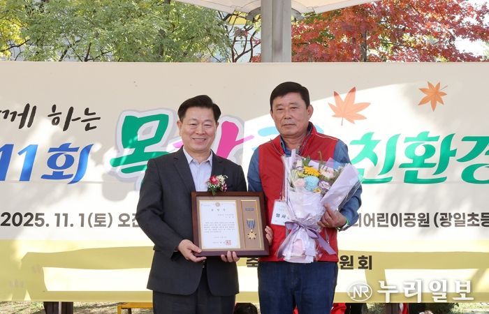 박승원 광명시장이 지난 1일 우리어린이공원에서 열린 ‘제11회 가족과 함께하는 목감천 친환경 축제’에 참석해 광명6동 주민자치회 위원에게 시장표창을 수여하고 기념사진을 촬영하고 있다.